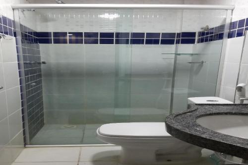 a bathroom with a shower and a toilet and a sink at Juazeiro Residence Hotel in Juazeiro do Norte