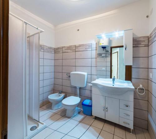 a bathroom with a toilet and a sink and a shower at Linz in Bibione