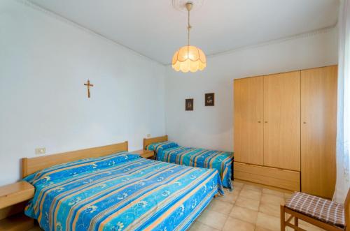 a bedroom with two beds and a cabinet at Manuela in Bibione