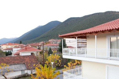a building with a balcony with mountains in the background at Villa PANORAMA in Levidi