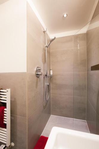 a bathroom with a shower and a sink at Stern am Rathaus in Cologne