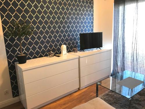 a living room with a dresser with a tv on it at Villahermosa Inn in Castellón de la Plana