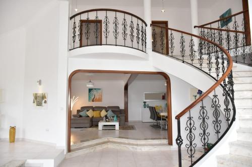 a staircase in a house with a living room at Mansion Almond - SEA, SUN and a charming refuge! in Paul do Mar