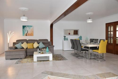 a living room with a couch and a table at Mansion Almond - SEA, SUN and a charming refuge! in Paul do Mar