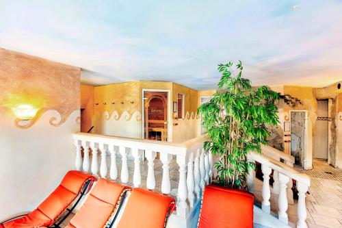 a staircase with orange chairs and a plant at Kur- und Wellnesshotel Förch in Bad Wörishofen