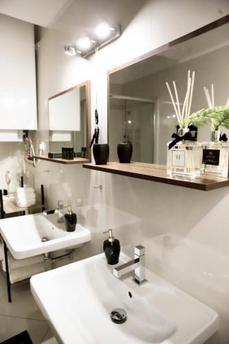 a bathroom with a sink and a mirror at CityLife Residence in Bratislava