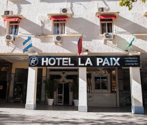 a hotel la pax sign in front of a building at Hotel De La Paix in Fès
