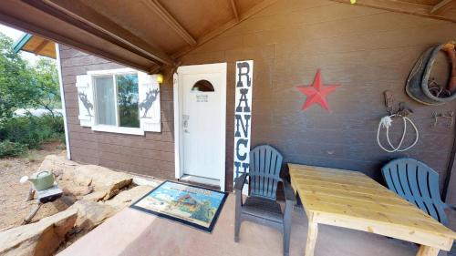 a porch with a table and two chairs and a star at Ranch Mountain Cabin, Stunning! Campfire, Hiking in Monticello