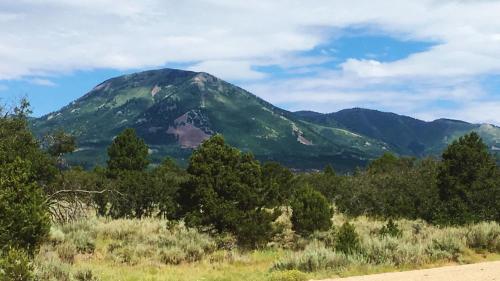 a mountain in the distance with trees in the foreground at Ranch Mountain Cabin, Stunning! Campfire, Hiking in Monticello