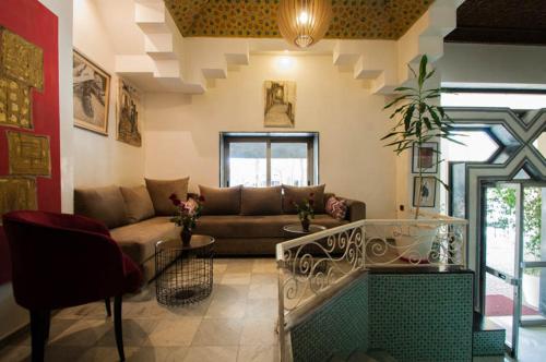 a living room with a couch and a table at Hotel De La Paix in Fès