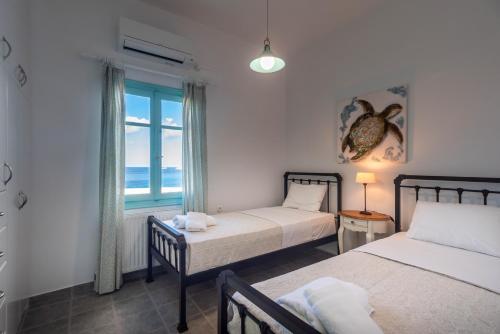 Säng eller sängar i ett rum på Villa Zefyros
