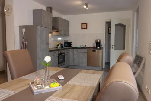 a kitchen and dining room with a table and chairs at Haus Sonnenschein in Witten