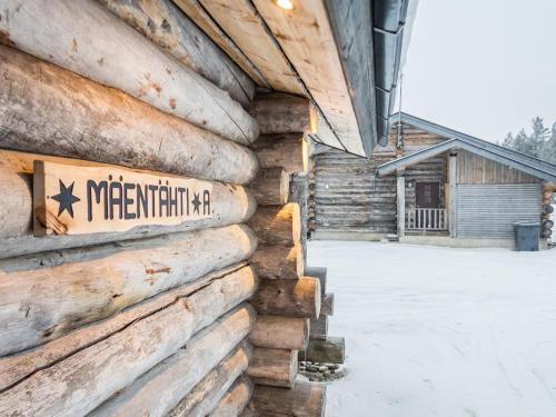 a sign on the side of a log building at Holiday Home Mäentähti a by Interhome in Ruka