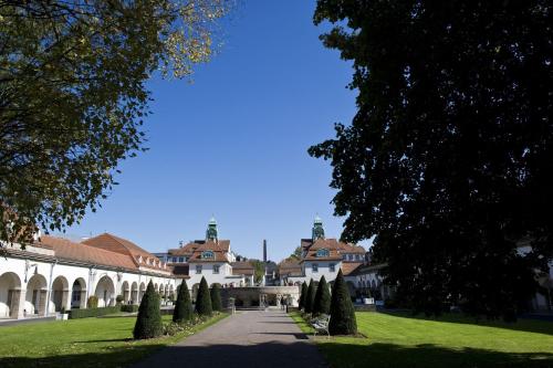 a view of the courtyard of a building with trees at Dolce by Wyndham Bad Nauheim in Bad Nauheim