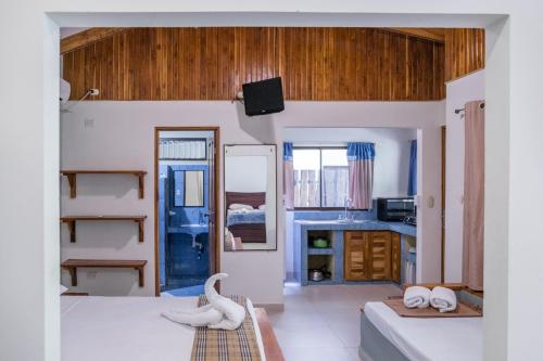 a room with a bedroom with a bed and a bathroom at Zula Inn Aparthotel in Santa Teresa Beach
