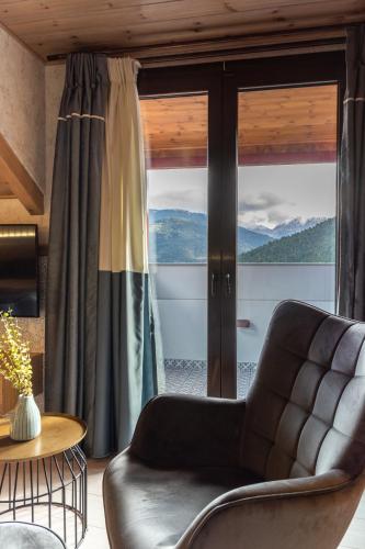 a living room with a couch and a large window at Villa Virginia Hotel in Karpenision