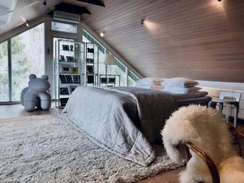 a bedroom with a bed and a teddy bear on a rug at Merenranta Huvila 210 m2 in Kokkola