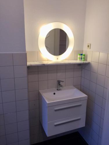 a bathroom with a sink and a mirror at trash de luxe in Schleswig