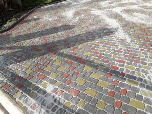 a shadow of a person on a mosaic floor at Садиба "Три Царі" in Yaremche