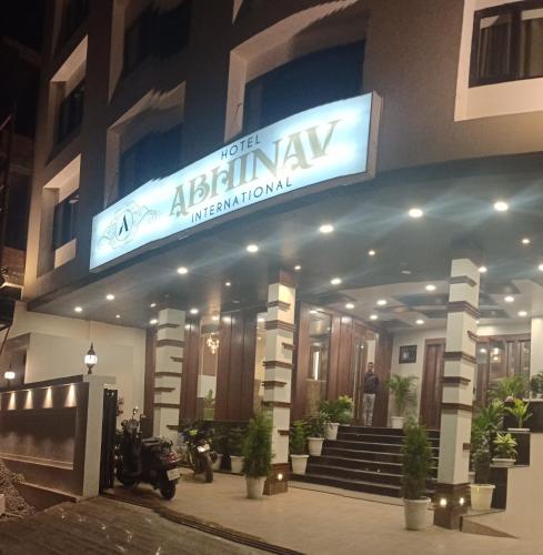 a man standing in front of a hotel at night at Hotel Abhinav International in Varanasi