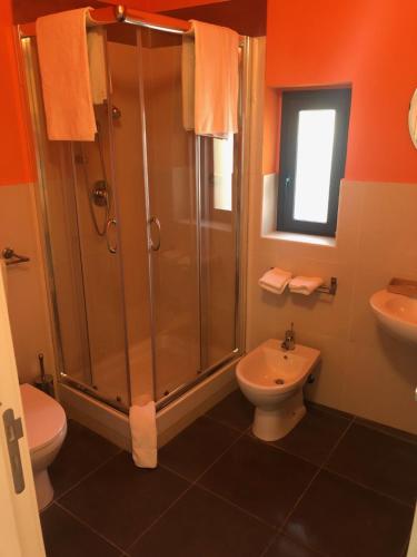 un bagno con doccia, WC e lavandino di San Giorgio Rooms a Caltagirone