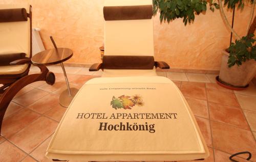 a sign on the back of a hospital appointment hoopalling chair at Aparthotel DAS Hochkönig in Ramsau am Dachstein