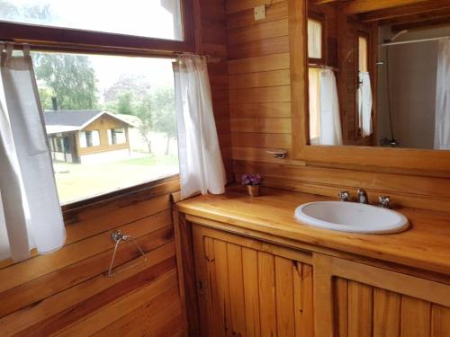 a bathroom with a sink and a window at Nahuel Mapi Lodge in Pilolil