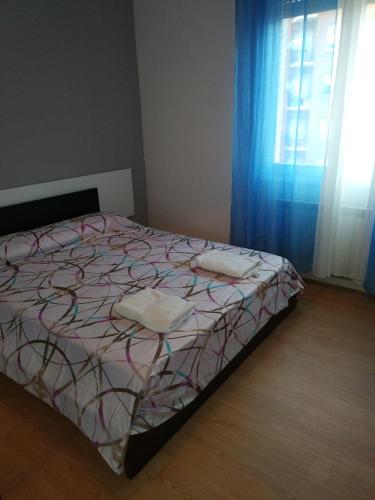 a bedroom with a bed and a window with blue curtains at Piso para grupos en Logroño in Logroño