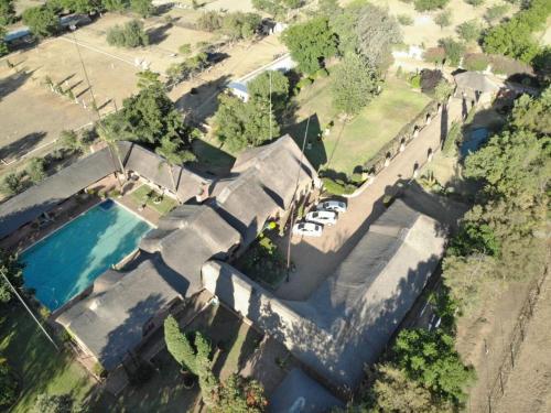 an overhead view of a house with a swimming pool at Owls Loft Guest House in Midrand