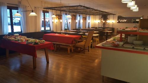 a restaurant with tables and chairs and a buffet at Råda Hotel in Hagfors