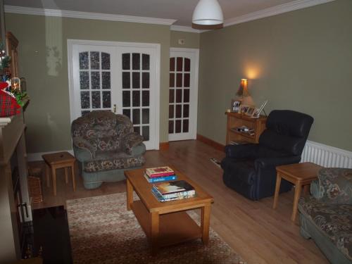 a living room with a couch chair and a table at Chez Sé in Drogheda