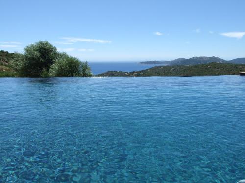 a large body of water with an island in the background at Chambres d'Hôtes Bianca Casa in Porto-Vecchio