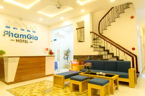 a lobby of a hotel with a couch and stools at PHAM GIA HOTEL Mui Ne in Mui Ne