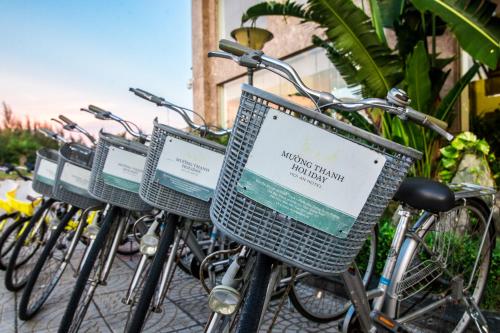 a row of bikes parked next to each other at Muong Thanh Holiday Hoi An Hotel in Hoi An