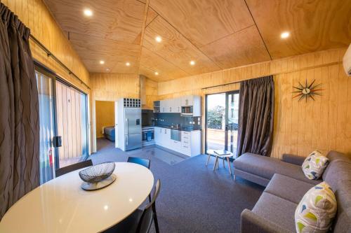 a living room with a couch and a table at Apartments at Queenstown TOP 10 Holiday Park in Queenstown