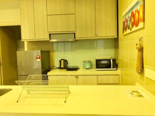 a kitchen with white cabinets and a counter top at CoZy Suite @ PJ & Sunway(2 Bedroom) in Petaling Jaya