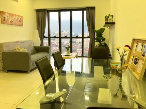 a living room with a glass table and a couch at CoZy Suite @ PJ & Sunway(2 Bedroom) in Petaling Jaya