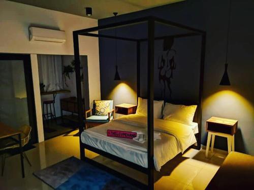 a bedroom with a canopy bed in a room at The Best Hotel in Bayan Lepas - THE LOV PENANG in Bayan Lepas