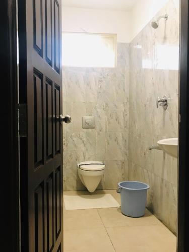 a bathroom with a toilet and a sink at Sri Gnana Vedha Beach Residency in Velānganni