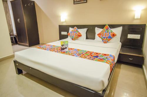 a bedroom with two beds in a room at Hotel Sunshine in Mysore