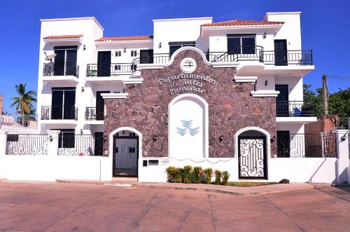 a building with a sign on the side of it at Departamentos Luminar in Mazatlán