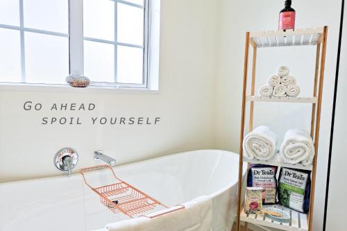 a bathtub with a towel rack next to a window at Kahurangi Twizel Hosted Bed & Breakfast in Twizel