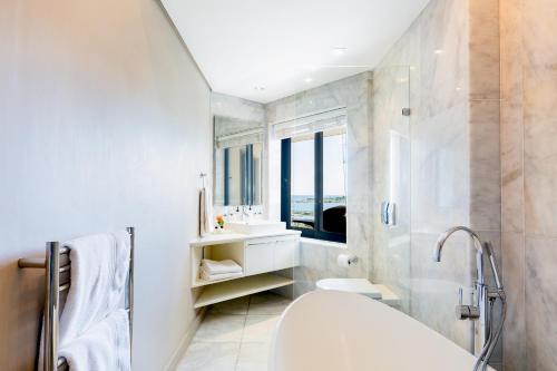 a bathroom with a toilet and a shower and a sink at Houghton View 13 Luxury Apartments in Cape Town