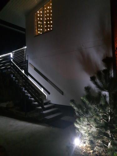 a christmas tree in front of a church at night at Guest House Serena in Chornomorsk