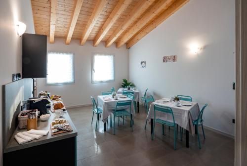 a dining room with tables and chairs in a room at B&B Terrebianche in Lavagno