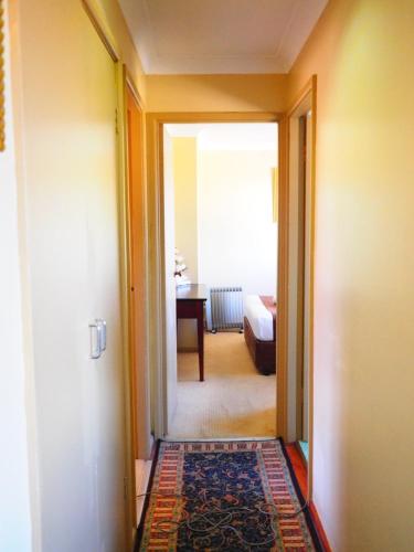 a hallway with a door leading to a room with a bedroom at Bella Vista Motel in Gosford