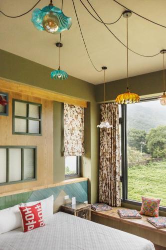 a bedroom with a bed and a large window at The Dawn B&B in Jian