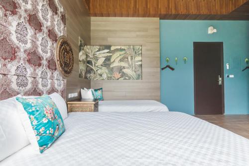 a bedroom with two beds and a blue door at The Dawn B&B in Jian