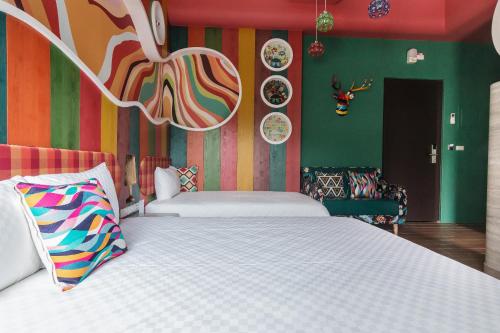a bedroom with a large bed and a colorful wall at The Dawn B&B in Jian