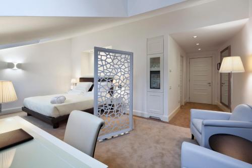 a bedroom with a bed and a living room at Maison Milano | UNA Esperienze in Milan